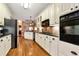 Modern kitchen with white cabinets, stainless steel appliances, and granite countertops for a luxurious feel at 1420 Arblay Pl, Loganville, GA 30052