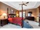 This is a luxurious main bedroom featuring tray ceiling, four poster bed and full ensuite bath at 1420 Arblay Pl, Loganville, GA 30052