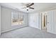 Spacious bedroom with ceiling fan and grey carpet at 5034 Hickory Hills Dr, Woodstock, GA 30188