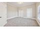 Bright and airy bedroom with neutral carpeting and ample closet space at 5034 Hickory Hills Dr, Woodstock, GA 30188