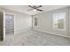 Well-lit bedroom with ceiling fan and grey carpet at 5034 Hickory Hills Dr, Woodstock, GA 30188