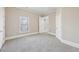 Well-lit bedroom featuring neutral walls and carpet at 5034 Hickory Hills Dr, Woodstock, GA 30188