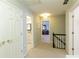 Upstairs hallway with carpet, doors to bedrooms and bath at 6320 Bannerhorn Run, Alpharetta, GA 30005