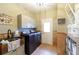 Laundry room with farmhouse sink, washer, dryer, and storage at 6320 Bannerhorn Run, Alpharetta, GA 30005