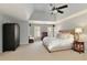 Main bedroom with carpeted floor, ceiling fan, and large windows at 6320 Bannerhorn Run, Alpharetta, GA 30005