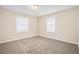 Well-lit bedroom with neutral carpet and two windows at 2159 Macon Sw Dr, Atlanta, GA 30315