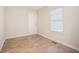 Spacious bedroom with wood-look floors and a window at 2159 Macon Sw Dr, Atlanta, GA 30315