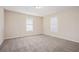 Large bedroom with neutral carpeting and two windows at 2159 Macon Sw Dr, Atlanta, GA 30315