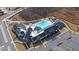 Aerial view of the community clubhouse, featuring a pool, hot tub, parking, and outdoor seating areas at 5860 Collier Bridge Ln, Hoschton, GA 30548
