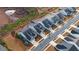 Bird's-eye view of neighborhood showcasing homes with various roof lines, driveways and adjacent street at 5860 Collier Bridge Ln, Hoschton, GA 30548