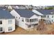 Back view of a home with a screened-in porch and a deck with stairs leading to the yard and neighborhood at 5860 Collier Bridge Ln, Hoschton, GA 30548