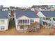 Back view of the home with screened-in porch and a deck overlooking the yard and adjacent houses at 5860 Collier Bridge Ln, Hoschton, GA 30548