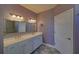 Bathroom with double sinks, white cabinets, decorative mirrors, and modern finishes at 5860 Collier Bridge Ln, Hoschton, GA 30548