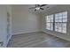Bright bedroom with stylish flooring, ample natural light, and a modern ceiling fan at 5860 Collier Bridge Ln, Hoschton, GA 30548