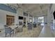 An elegant room featuring a cozy fireplace, a TV, bookshelves, and comfortable seating areas at 5860 Collier Bridge Ln, Hoschton, GA 30548