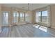 Dining area with chandelier, hardwood floors, large windows, and access to outdoor deck at 5860 Collier Bridge Ln, Hoschton, GA 30548