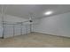 A clean garage interior with white walls, concrete floor, and an automatic garage door opener at 5860 Collier Bridge Ln, Hoschton, GA 30548