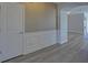 Elegant entryway with detailed wainscoting, designer wallpaper, and durable wood-look flooring at 5860 Collier Bridge Ln, Hoschton, GA 30548