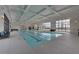 A well-lit indoor pool area with seating and large windows overlooking the outdoor scenery at 5860 Collier Bridge Ln, Hoschton, GA 30548