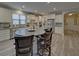 Open kitchen featuring a large island, stainless steel appliances, and stylish gray backsplash at 5860 Collier Bridge Ln, Hoschton, GA 30548