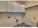 Utility room with sink, washer and dryer connections, and storage cabinets at 5860 Collier Bridge Ln, Hoschton, GA 30548