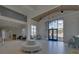A grand lobby featuring a seating area, high ceilings, large windows, and elegant chandeliers at 5860 Collier Bridge Ln, Hoschton, GA 30548