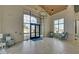 A grand lobby featuring a seating area, high ceilings, large windows, and elegant chandeliers at 5860 Collier Bridge Ln, Hoschton, GA 30548