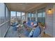Cozy screened patio with comfortable seating, ceiling fan, and view of the surrounding community at 5860 Collier Bridge Ln, Hoschton, GA 30548