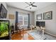 Bright home office features hardwood floors, built-in shelving, and large window at 1010 Woodward Park Dr, Suwanee, GA 30024