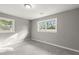 Bright bedroom with neutral walls, gray carpeting, and multiple windows at 1955 E Lake Dr, Marietta, GA 30066