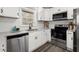 White kitchen cabinets, granite countertops, stainless steel appliances, and subway tile backsplash at 1955 E Lake Dr, Marietta, GA 30066