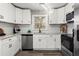 Modern kitchen featuring white shaker cabinets, granite countertops, and stainless steel appliances at 1955 E Lake Dr, Marietta, GA 30066