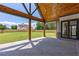 Covered patio overlooks a large backyard with wood ceiling and beams at 1095 Lanier Pl, Cumming, GA 30041