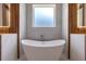 Bathroom with free-standing tub and wood accent wall at 1095 Lanier Pl, Cumming, GA 30041