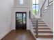 Elegant entryway with hardwood floors, staircase and dark wooden door at 1095 Lanier Pl, Cumming, GA 30041