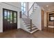 Elegant entryway with hardwood floors, staircase and dark wooden door at 1095 Lanier Pl, Cumming, GA 30041