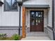 Dark wooden front door with glass panels, flanked by gray brick at 1095 Lanier Pl, Cumming, GA 30041