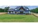 Modern farmhouse with a large backyard and covered patio at 1095 Lanier Pl, Cumming, GA 30041