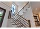 Modern staircase with sleek metal railing and hardwood steps at 1095 Lanier Pl, Cumming, GA 30041