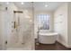 Spa-like bathroom with a large walk-in shower and soaking tub at 1240 Woodlawn Ne Dr, Marietta, GA 30068