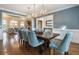 Elegant dining room with blue chairs and a view of the living room at 1240 Woodlawn Ne Dr, Marietta, GA 30068