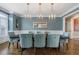 Elegant dining room featuring a large table, blue chairs, and stunning light fixtures at 1240 Woodlawn Ne Dr, Marietta, GA 30068