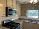 Updated kitchen with stainless steel appliances and granite countertops at 1737 Ramblewood Way, Snellville, GA 30078