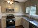 Updated kitchen with stainless steel appliances and granite countertops at 1737 Ramblewood Way, Snellville, GA 30078