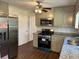 Updated kitchen with stainless steel appliances and granite countertops at 1737 Ramblewood Way, Snellville, GA 30078