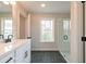 Bathroom featuring a modern vanity, window for natural light, and a glass-enclosed shower at 3311 Cranston Ln, Kennesaw, GA 30144