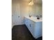 Double vanity bathroom with white cabinets and dark hexagon tile floors at 3311 Cranston Ln, Kennesaw, GA 30144