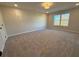 Spacious bedroom with neutral carpeting and a large window at 3311 Cranston Ln, Kennesaw, GA 30144