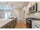 Modern kitchen featuring white cabinets, quartz countertops, and stainless steel appliances at 3311 Cranston Ln, Kennesaw, GA 30144