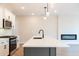 Modern kitchen with white cabinets, quartz countertop, and built in fireplace at 3311 Cranston Ln, Kennesaw, GA 30144